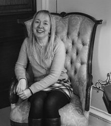 black and white photo of Hayley Cotterill, seated.