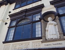 Angled colour photograph of the statue of Nightingale on the side of the Boots building in Derby.