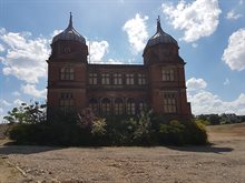 Colour photograph of one of the 'pepper pot' buildings at Derbyshire Royal Infirmary, surrounded by wasteland where the rest of the hospital used to be.