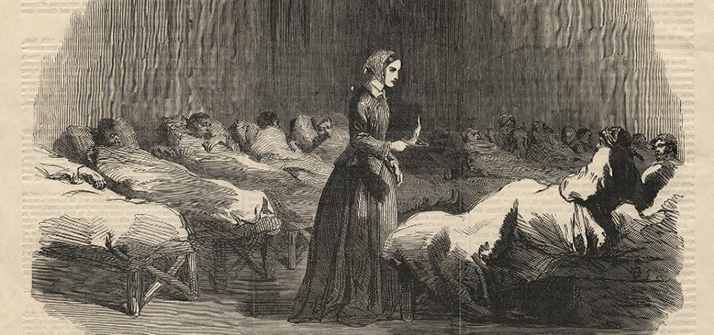 1855 wood engraving of Nightingale wearing a shawl and carrying a candle, in a ward at Scutari hospital among the soldiers' beds.