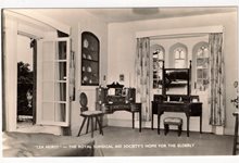 Black and white photograph of a room at Lea Hurst, including some 19th century style mahogany furniture.