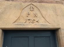 Photograph of an inscription above a door at Lea Hall which reads 'P.N. 1754'.