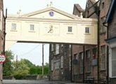 Colour photo of the elevated walkway associated with the John Smedley factory