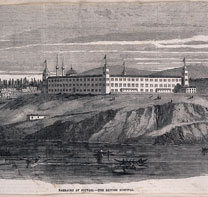 Wood engraved image of the exterior of the barrack hospital, Scutari. The hospital, a large square building, sits on a hill overlooking the water of the Bosphorus.
