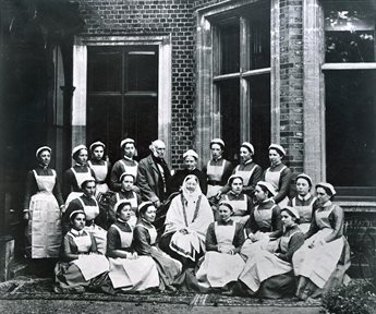 Nightingale and Sir Harry Verney posing at the centre of a group of 16 nurses outside Claydon House.
