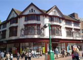 Colour photo of the exterior of the Boots building, Derby, featuring statues of Nightingale and other local historical figures.